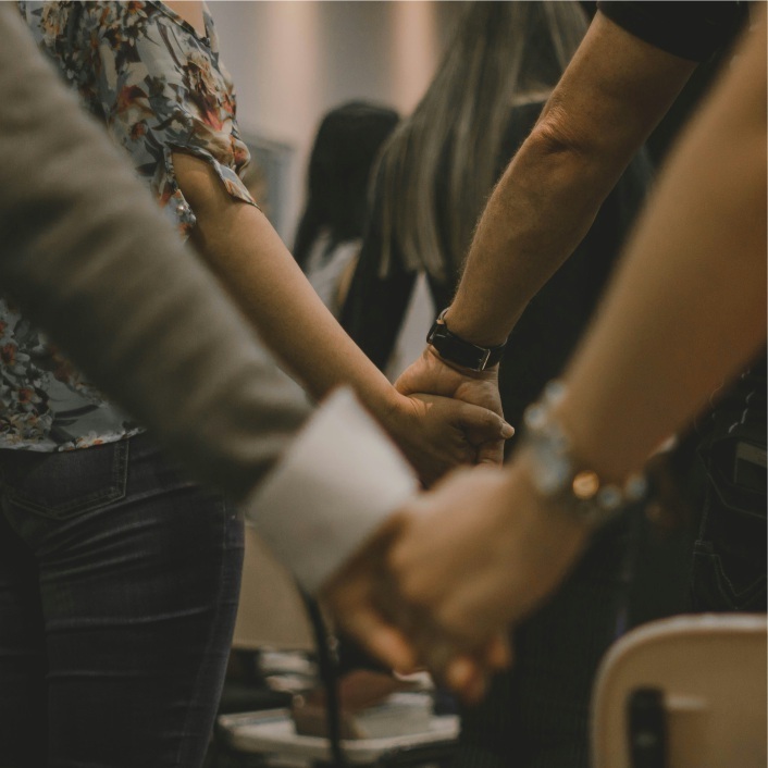 sets of hands clasped together